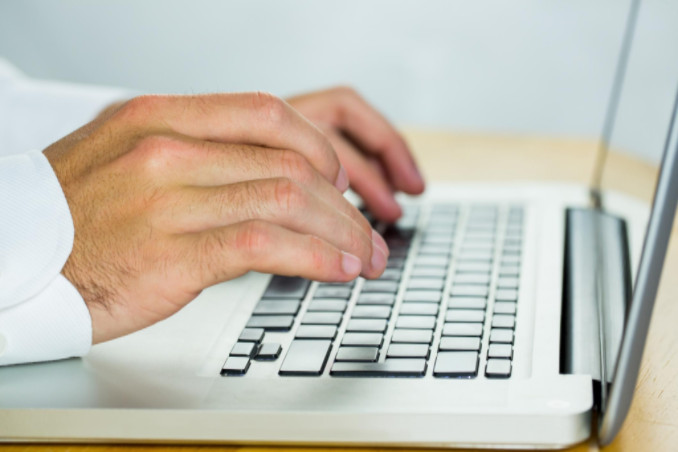 lawyer using laptop at desk: SEOLegal Law Firm Copywriting Blog